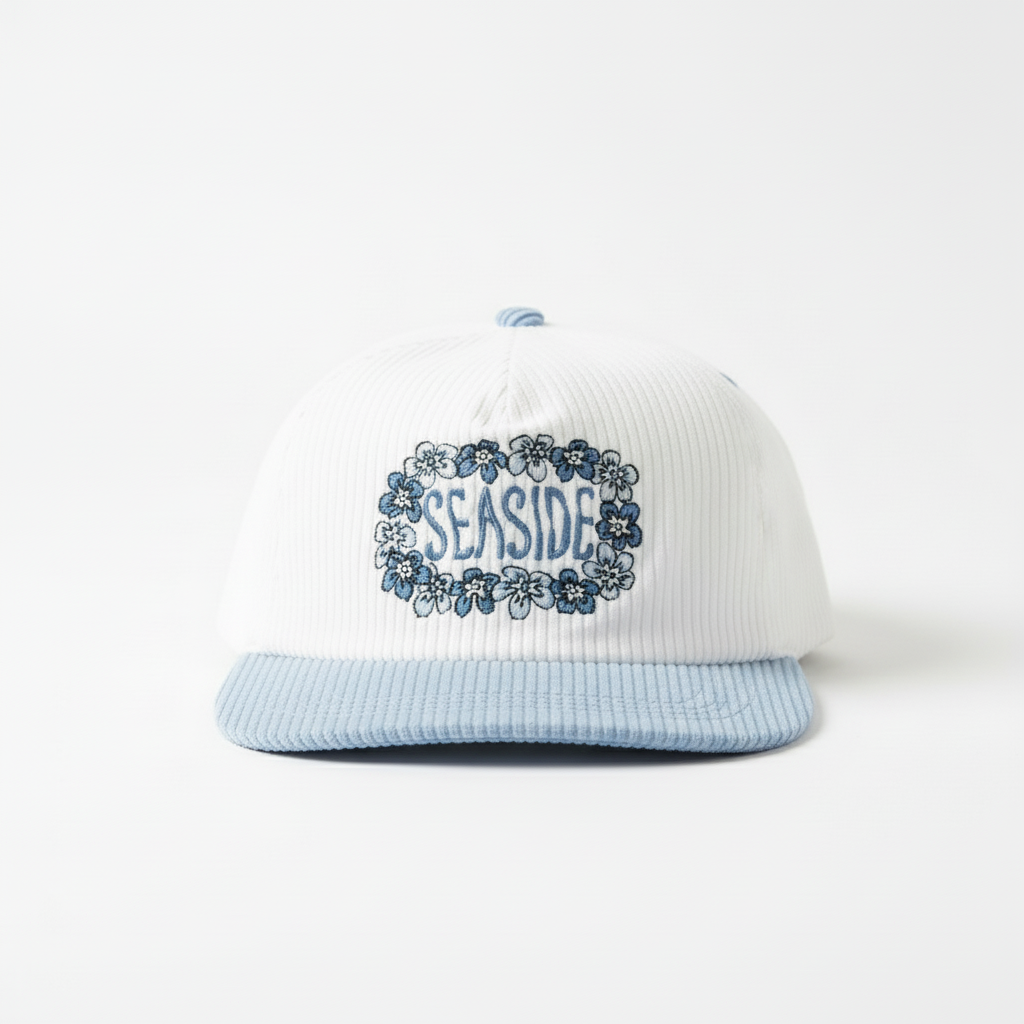 White and light blue cap with 'Seaside' floral design on a white background