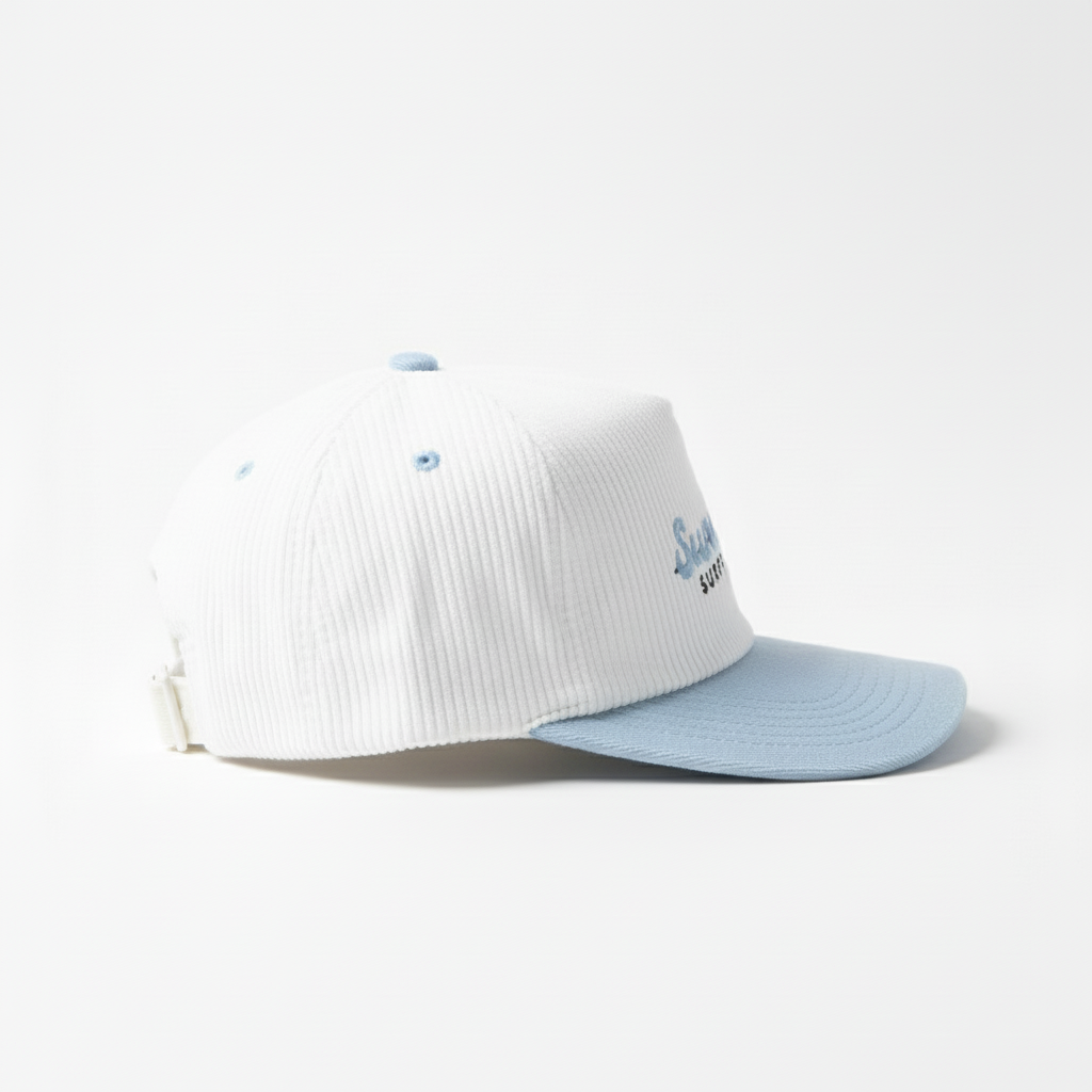 White cap with blue visor and 'Surfblaze Surfboards' logo on a white background