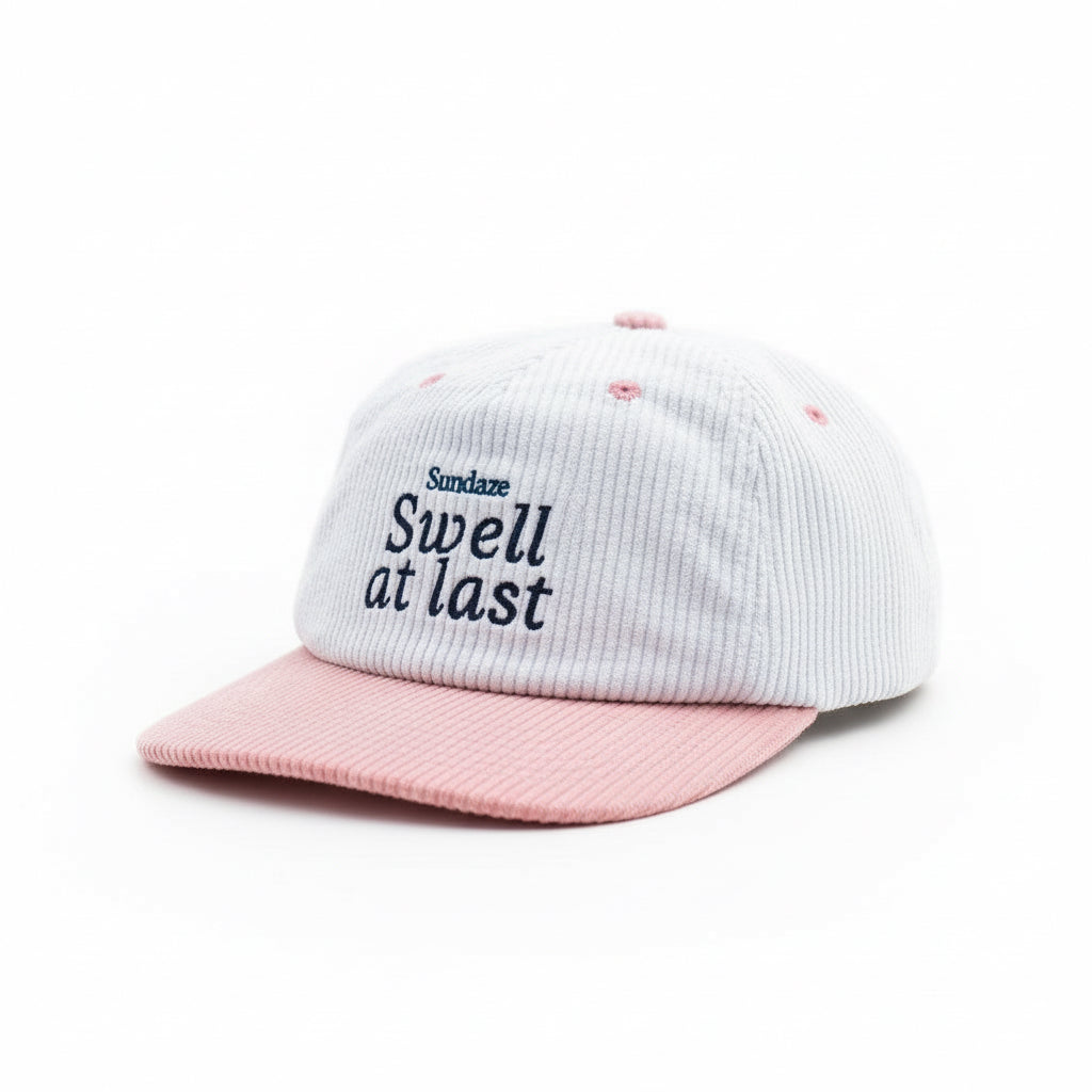 Pink and white cap with 'Sundaze Swell at last' text on a white background