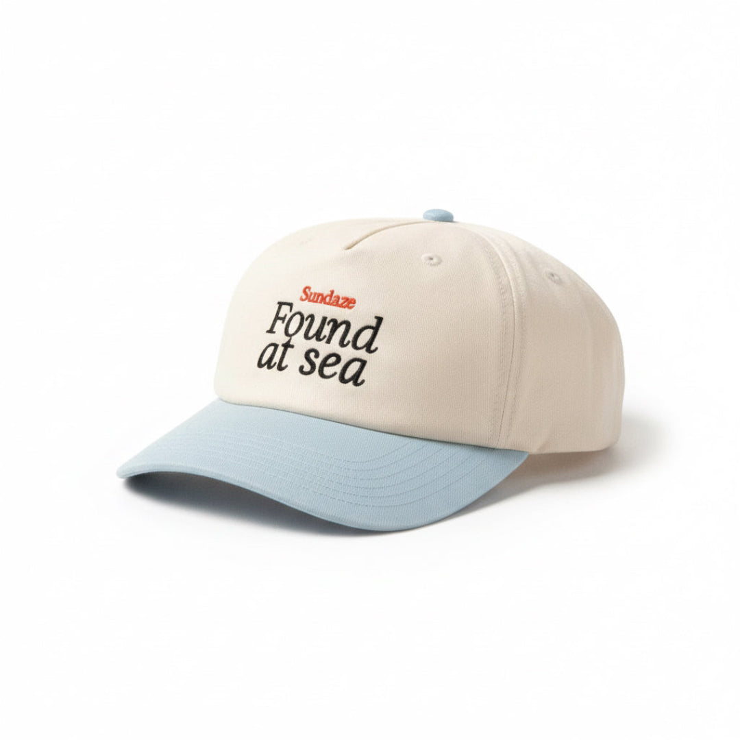 Beige and light blue cap with text on a white background